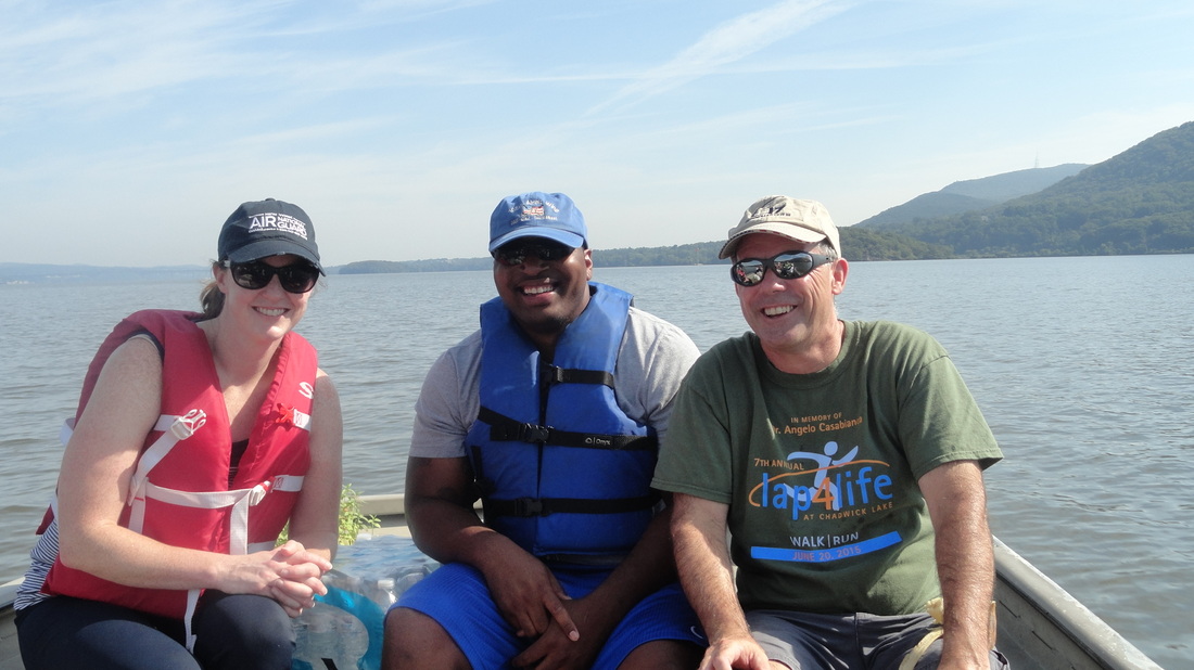 a man and a woman sitting on a boat in a body of water