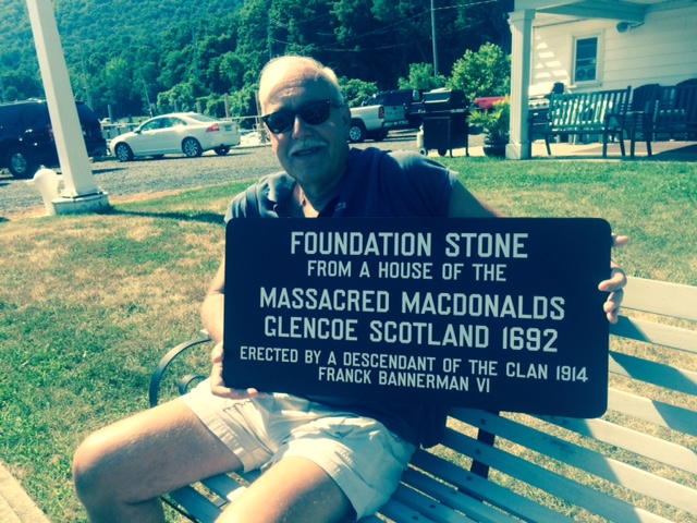 a person sitting on a bench reading a book