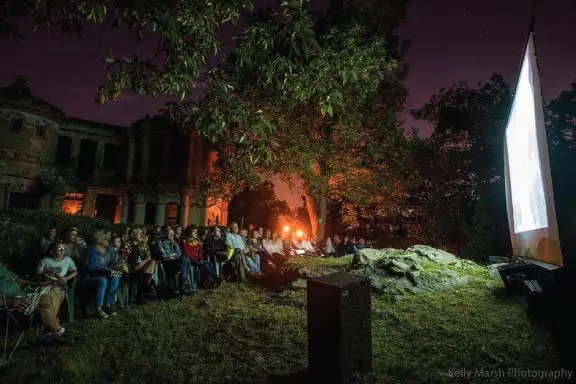 a group of people that are standing in the grass