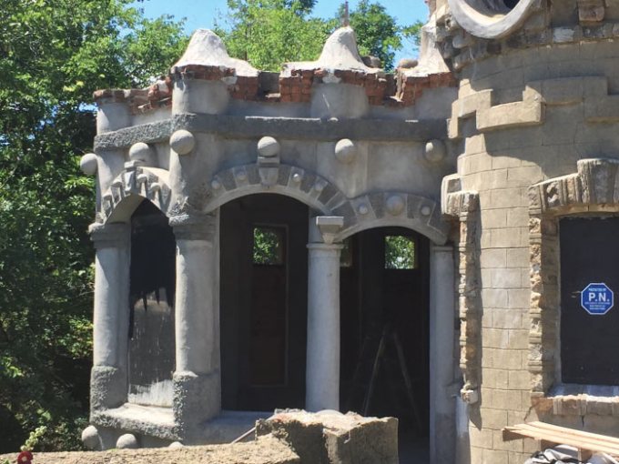 a large stone statue in front of a building