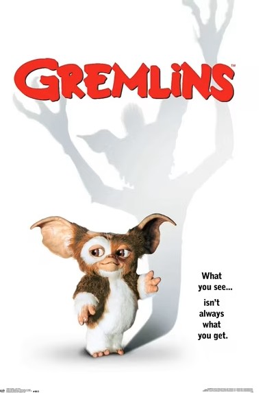 Poster of 'Gremlins' with a small furry creature and its large shadow.