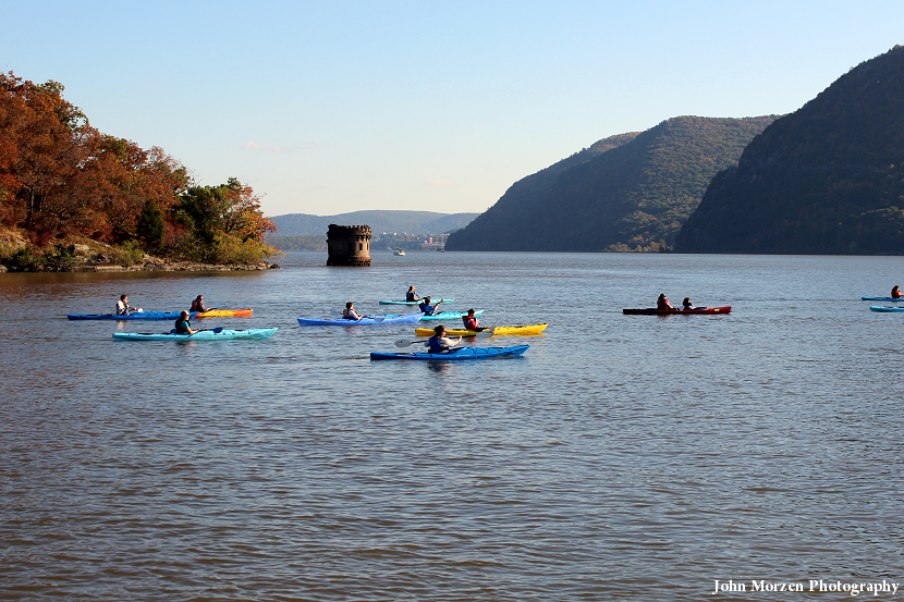 a group of people rowing a boat in a body of water