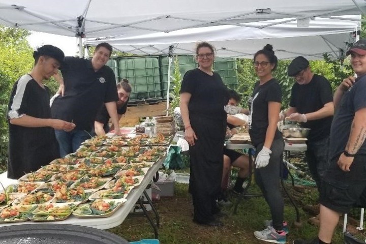 a group of people standing around a table