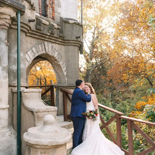 a person standing in front of a stone building