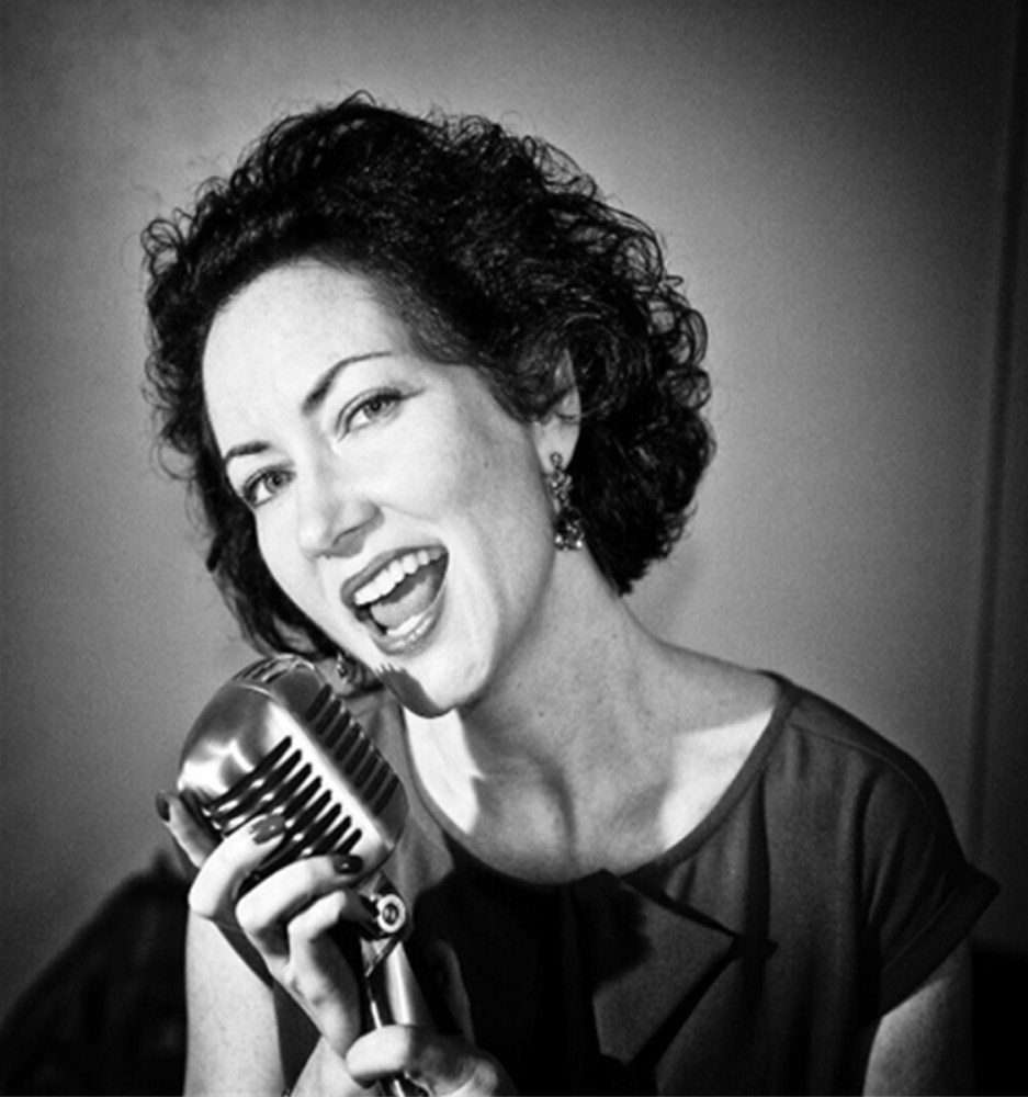 a person holding a microphone posing for the camera