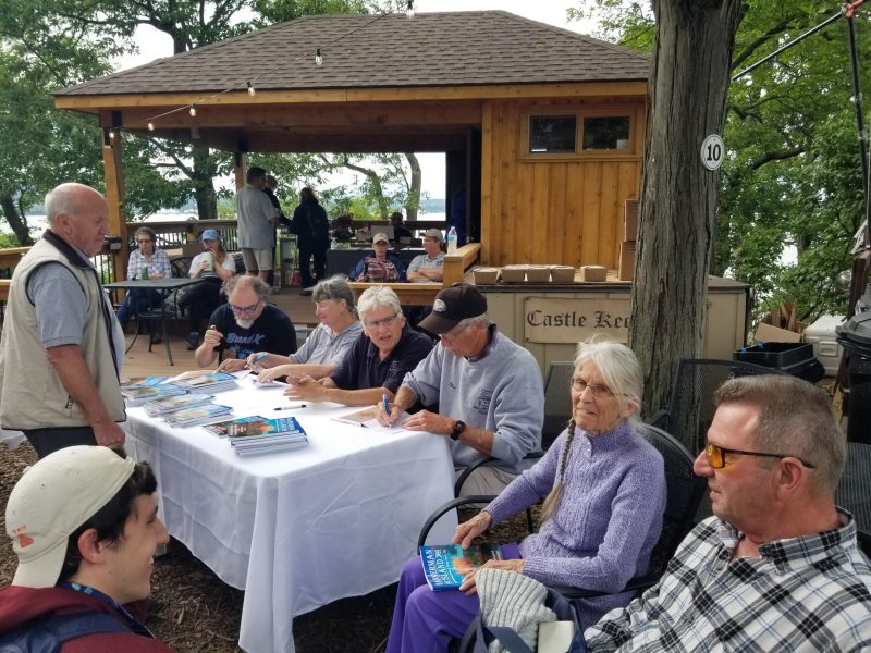 a group of people sitting at a picnic table