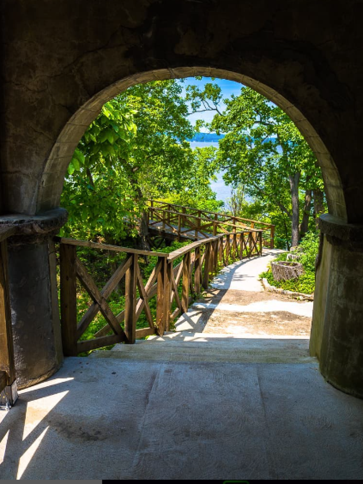 a stone building that has a bridge in the background