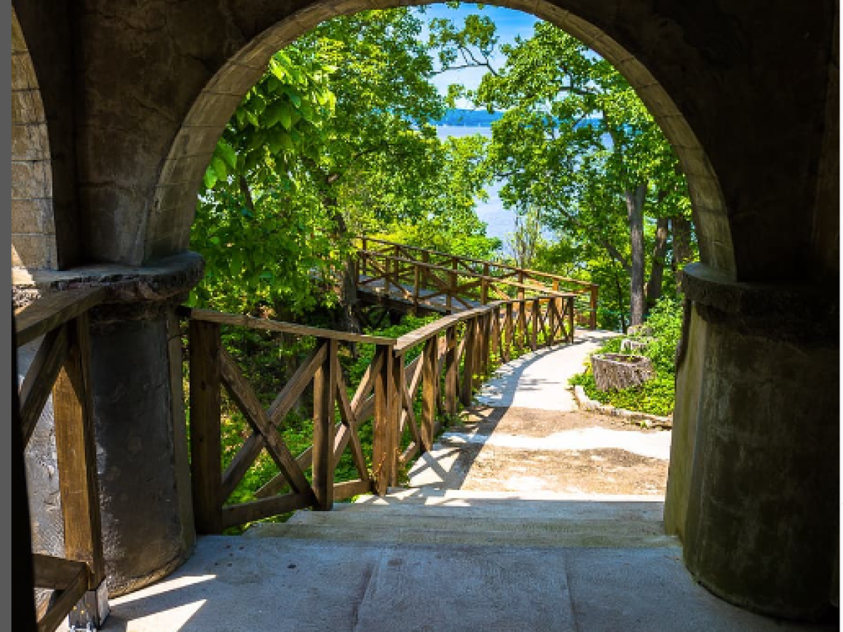 a stone building that has a bridge in the background