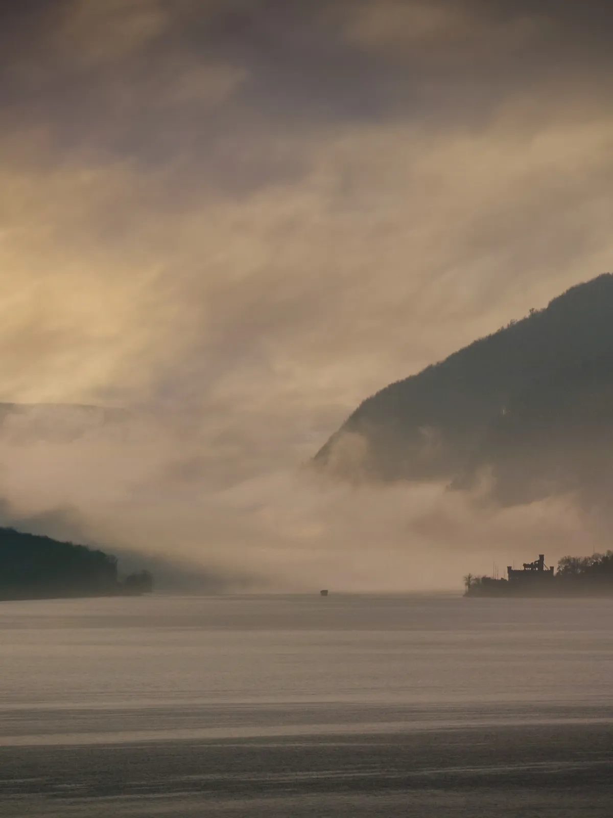 a large body of water with a mountain in the background